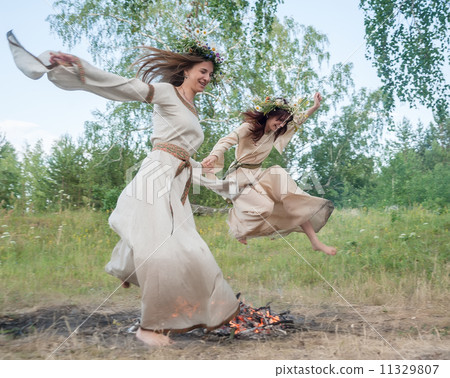 Attractive girls jump through fire 11329807