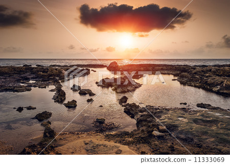 sunset over the sea and rocky coast sunset over the sea and rocky coast 11333069