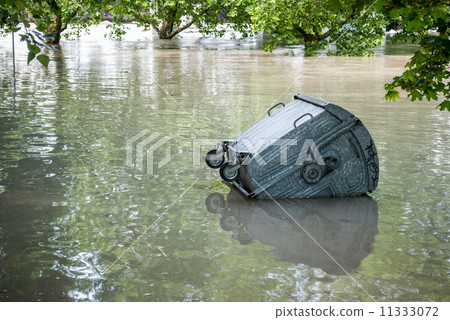 Floating dumpster in flood Floating dumpster in flood 11333072