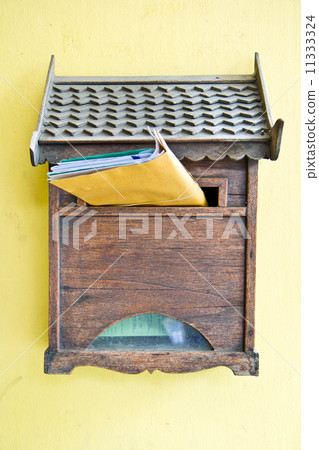 Cloes up of a wooden mailbox in front of home 11333324