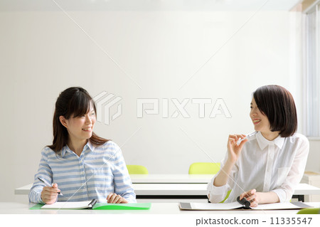 Two women studying in the classroom 11335547