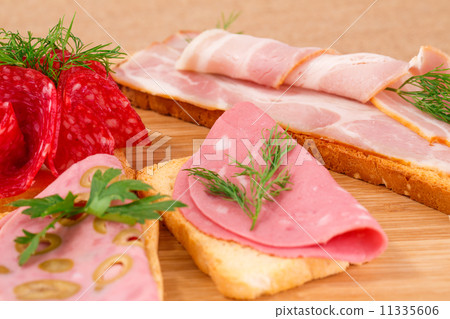 Sandwiches with salami, bacon and mortadella 11335606