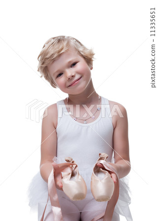 Smiling little blonde posing with pointe shoes 11335651