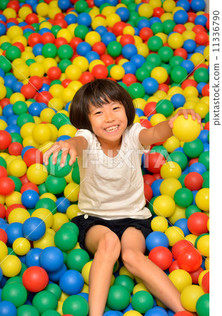 Girls playing in the ball pool 11336790