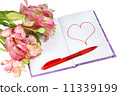 notebook with a pen by flowers and heart 11339199