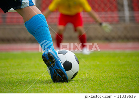 Attack soccer player shooting to defense team Attack soccer player shooting to defense team 11339639