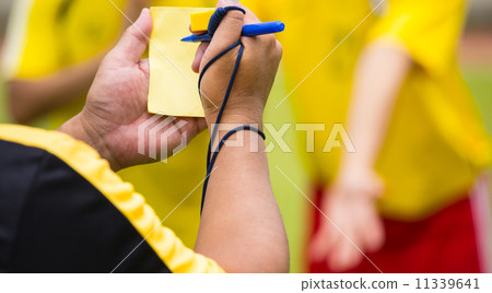 Referee soccer show card for warning and recorded player foul Referee soccer show card for warning and recorded player foul 11339641