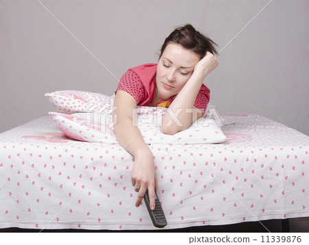 young girl fell asleep with remote control in bed 11339876