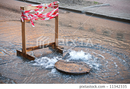 Danger border near water leak on the road Danger border near water leak on the road 11342335