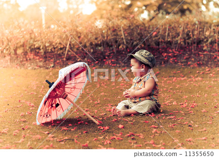 Vintage of Baby sitting alone  with umbella 11355650
