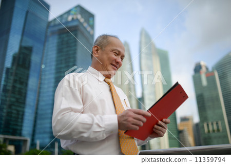 Businessman reading document 11359794