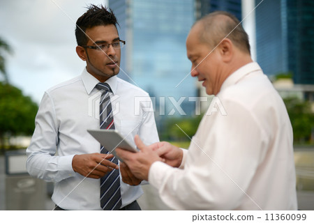 Businessman having discussion using tablet 11360099