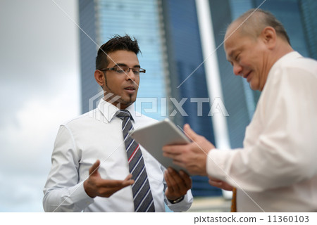 Businessman having discussion using tablet 11360103