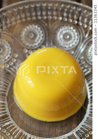 Mango pudding solidified with gelatin served in a glass dish 11363345