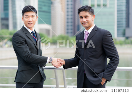 Successful businessmen shaking hands after sealing cooperation agreement 11367313