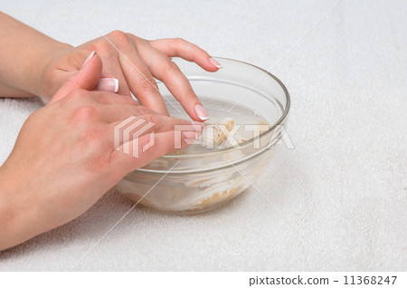 Hands in water with seashells 11368247