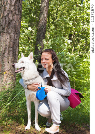 The young woman with a white dog on the nature The young woman with a white dog on the nature 11371670