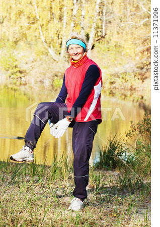 Woman making of the stretching in full nature 11371996