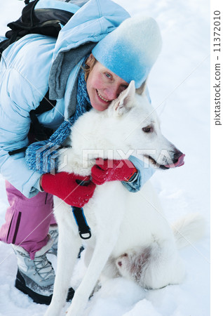 The woman with a dog in winter on walk 11372010