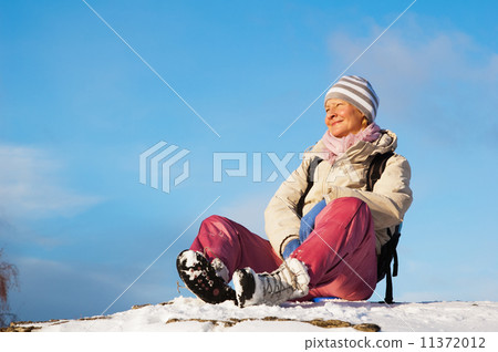 woman sitting outdoors and enjoy the Sun 11372012