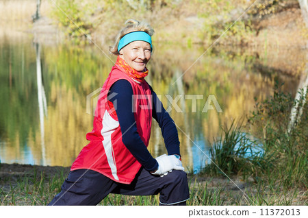 Woman making of the stretching in full nature 11372013