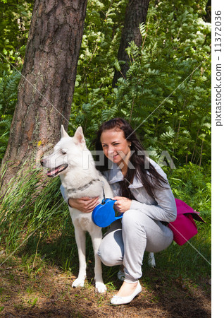 The young woman with a white dog on the nature The young woman with a white dog on the nature 11372036