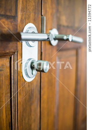 modern chrome door handle on a wooden door 11394772