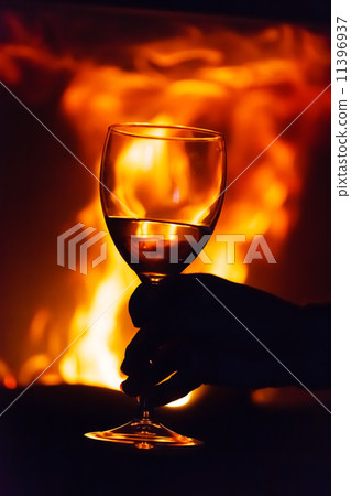 glass of wine beside the fire 11396937