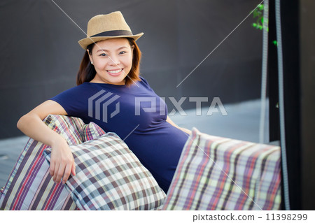 young pregnant woman sitting,charming smile young pregnant woman sitting,charming smile 11398299