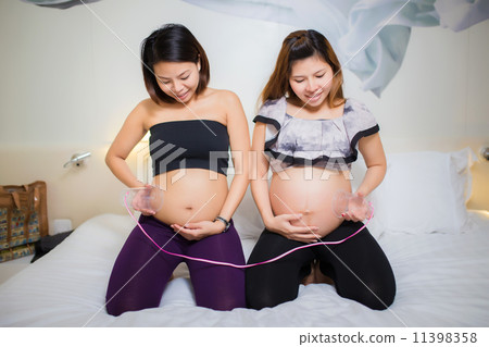 Two beautiful pregnant Asian women. Are happy Two beautiful pregnant Asian women. Are happy 11398358