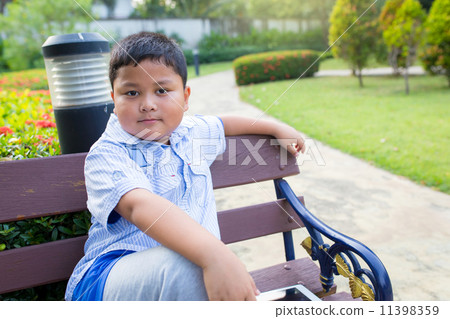 Asian boys Sit in the garden Asian boys Sit in the garden 11398359