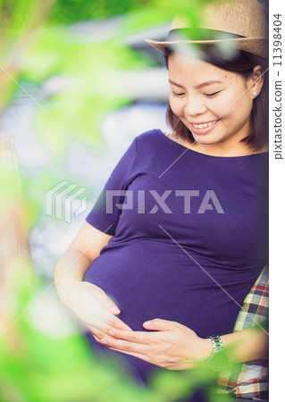 young pregnant woman sitting,charming smile young pregnant woman sitting,charming smile 11398404