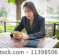 Beautiful Asian business woman using mobile for communication 11398506