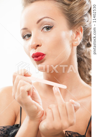 Sexy woman polishing fingernails Sexy woman polishing fingernails 11402530