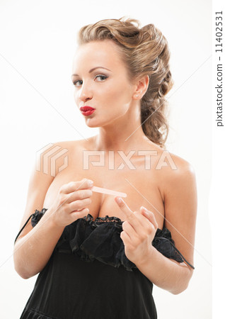 Sexy woman polishing fingernails Sexy woman polishing fingernails 11402531