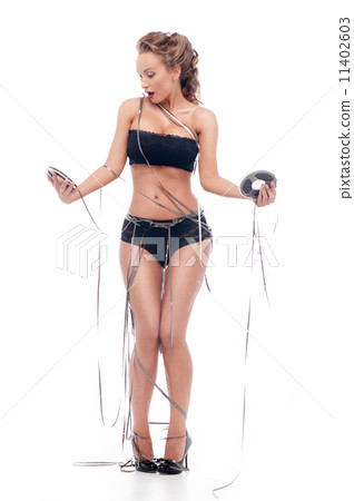 Attractive woman with an audio retro bobbins Attractive woman with an audio retro bobbins 11402603