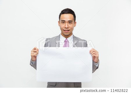 Young Asian businessman holds up a blank sign with room for adding text. Isolated on white. 11402822