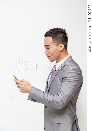 Young Asian businessman test messaging 11402962