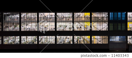 Wall with windows of an empty office building at night 11403343