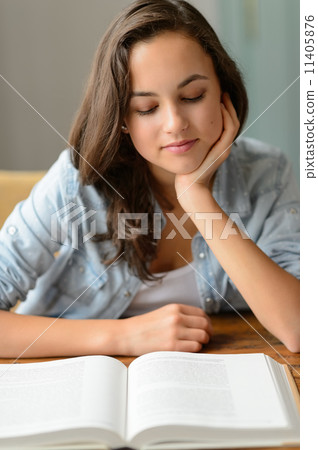 Student teenage girl reading book at home Student teenage girl reading book at home 11405876