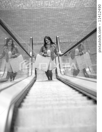 Black and white photo of smiling shopping woman Black and white photo of smiling shopping woman 11412490
