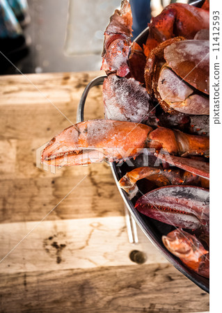 crab claw against wooden board 11412593