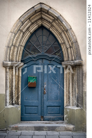 Fragment an ancient build with blue Gothic wooden door Fragment an ancient build with blue Gothic wooden door 11412824