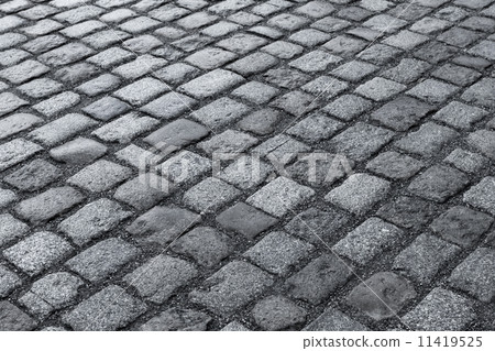 Old wet stone paved avenue street road 11419525