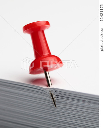 Drawing pin in paper pile Drawing pin in paper pile 11421173