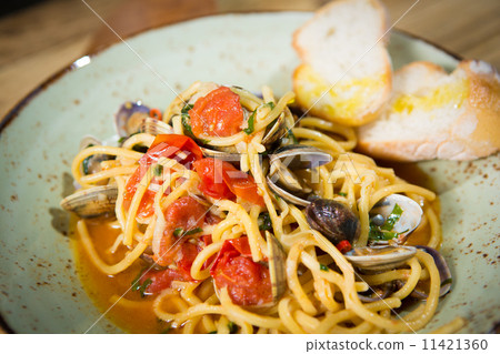 Homemade pasta with seafood and cherry tomatoes Homemade pasta with seafood and cherry tomatoes 11421360
