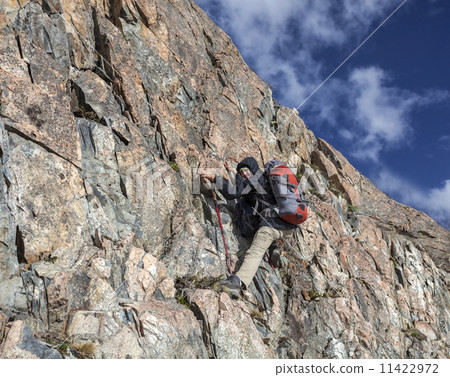 Female hiker climbing with backpack Female hiker climbing with backpack 11422972
