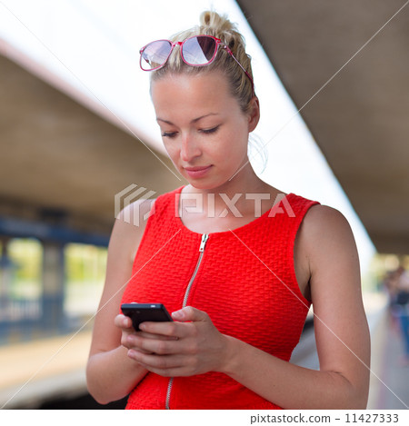 Young woman on platform of railway station. Young woman on platform of railway station. 11427333