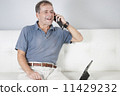 Adult male communicating with a friend on a mobile. 11429232