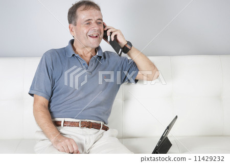 Adult male communicating with a friend on a mobile. 11429232